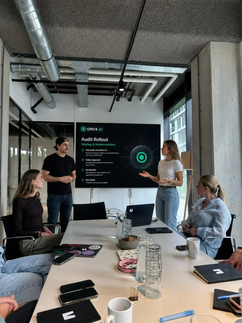 The ORVX AI team presenting a media buying audit and rollout strategy in a boardroom